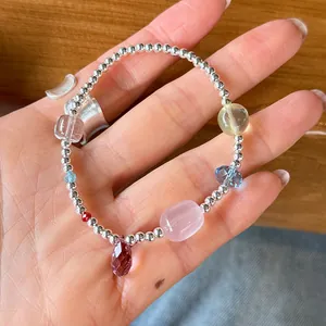 Detailed view of 925 sterling silver beaded bracelet with colorful crystals on hand
