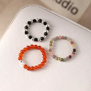 Set of three elastic beaded rings with 925 silver, agate, and tourmaline gemstones.