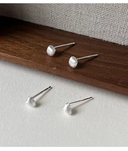 Detailed macro view of 990 sterling silver matte geometric stud earrings for women