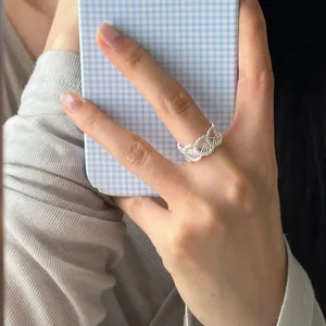 Elegant 925 sterling silver lace filigree openwork ring worn on a finger for detail view