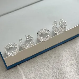 Macro view of 925 sterling silver lace openwork rings on a book edge