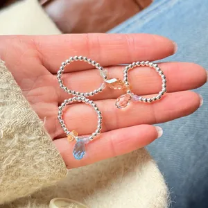 Detail view of handmade 925 sterling silver beaded rings with colorful crystal charms