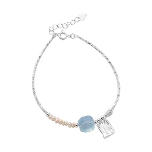 Elegant 925 sterling silver bracelet featuring freshwater pearls and blue aquamarine stone