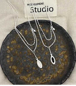 Detailed macro view of 925 sterling silver necklaces with oval black agate and white chalcedony
