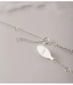Close-up view of 925 sterling silver necklace clasp with S925 stamp detail.