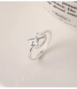 Detailed view of a minimalist 999 silver adjustable ring with unique gourd coin design