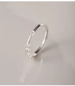 Close-up detail of a 999 pure silver adjustable ring with engraved gourd and coin patterns