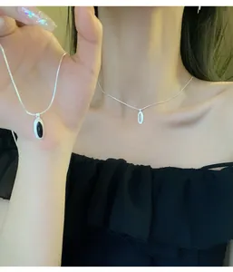 Elegant 925 sterling silver snake chain necklace featuring an oval black onyx pendant.