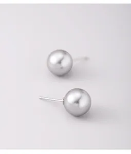 Close-up detail of round grey pearl stud earrings with 925 sterling silver posts