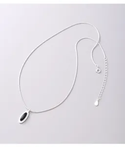 Detailed macro view of 925 sterling silver snake chain necklace with black agate pendant