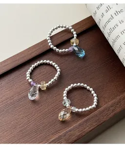 Macro view of three 925 sterling silver beaded rings with various colored crystal charms
