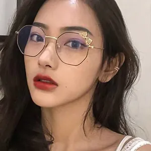 Detailed close-up showing a minimalist double-band golden ear cuff worn by an Asian model