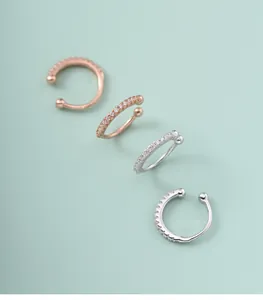 Close-up of four 925 sterling silver diamond-set ear cuffs for non-pierced ears.