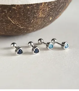 Macro view of 925 sterling silver heart stud earrings with blue cubic zirconia stones