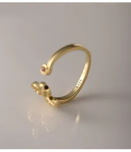 Detailed macro view of gold-plated S925 sterling silver open ring with red zircon