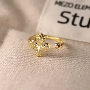Elegant 925 sterling silver gold-plated open ring with hollowed clover design and red zircon
