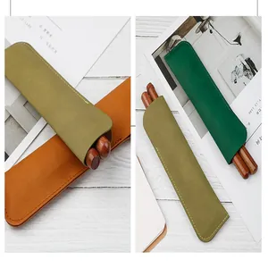 Detail of vintage PU leather double pen sleeves in olive and emerald green