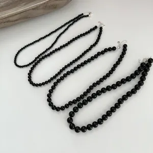 Close-up comparison of four black agate beaded necklaces with S925 sterling silver clasps