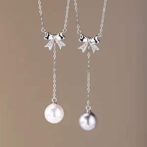 Elegant 925 sterling silver bow necklace with lustrous white and grey pearl drops