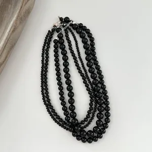 Close-up detail of multi-strand black onyx bead necklace with silver sterling clasp