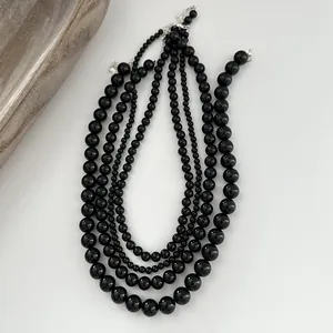 Detailed view of multi-layered black agate bead necklaces with S925 sterling silver clasps