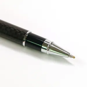 Professional macro view of a carbon fiber metal rollerball pen with a chrome-finished tip