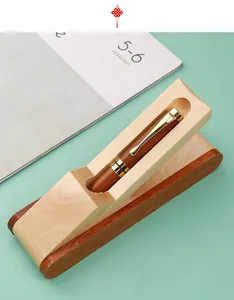 Detailed macro shot of vintage wooden ballpoint pen resting in its matching display gift box