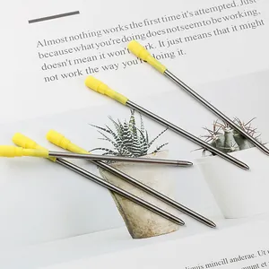 Set of five 82mm metal ballpoint pen refills with yellow caps on white background