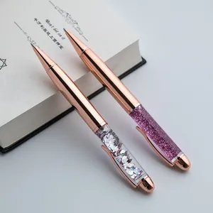 Detailed macro view of elegant rose gold ballpoint pens with silver and purple sequins