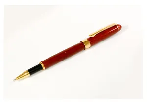 Detailed view of a vintage mahogany rollerball pen with elegant gold metal accents