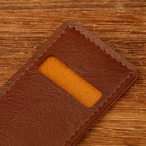 Close-up of vintage brown PU leather pen sleeve with soft orange lining and fine stitching