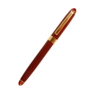Vintage rosewood rollerball pen with elegant gold trim and metal clip for office