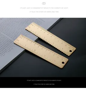 Detailed close-up of a 12cm vintage brass ruler with dual metric and imperial scales
