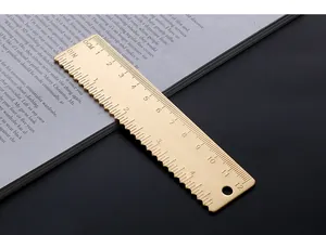 Detailed macro view of a 12cm brass ruler with dual metric and inch scales