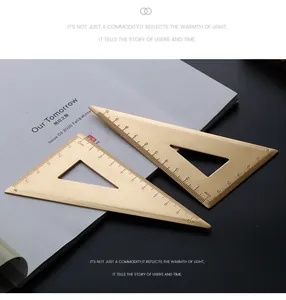 Detailed close-up of two vintage brass triangle rulers with precise metric scales
