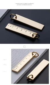 Detailed macro view of 6cm brass ruler keychain showing scales and brushed metal texture