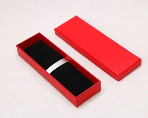 Macro view of an open red rectangular gift box with black velvet lining and ribbon