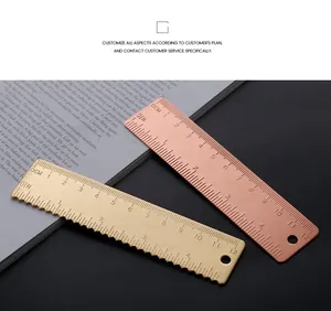 Detail view of vintage brass and copper EDC rulers with metric and imperial scales