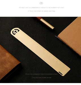 Detailed macro view of a vintage brass 15cm ruler bookmark with laser-engraved scale marks.