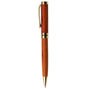 Vintage wooden ballpoint pen with gold brass clip for business and office signature.