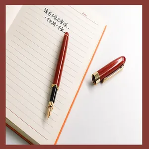 Detailed view of the redwood texture and iridium nib of this luxury fountain pen