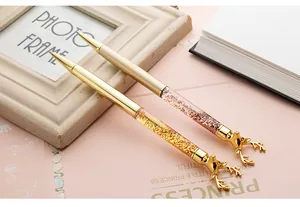 Elegant gold and rose gold reindeer head ballpoint pens with liquid glitter sand barrels.