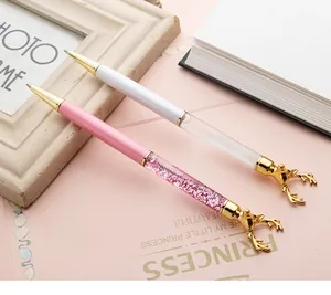 Close-up of creative quicksand reindeer pens with gold elk head toppers and glitter.