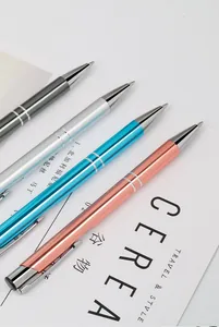 Detail of four colorful aluminium retractable metal ballpoint pens on a white background