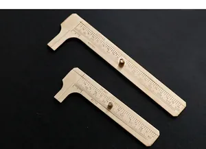 Close-up detail of vintage brass vernier calipers featuring dual metric and inch scales