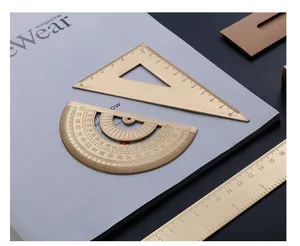 Close-up of vintage brass ruler set with precise engraved scale markings for drafting