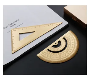 Macro detail of vintage brass triangle ruler and protractor with laser etched scales