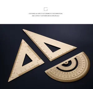 Macro detail of vintage brass measuring tool set including triangle ruler and protractor