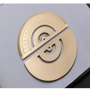 Macro detail of the 180-degree laser-engraved markings on a vintage brass metal protractor.