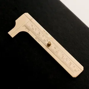 Mini brass vernier caliper with dual metric and imperial scale for pocket measuring.